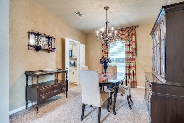 105 Cassandra Dr, Forney, TX 75126 - dining area featuring a chandelier, a textured wall, light colored carpet, and baseboards