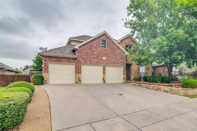 105 Cassandra Dr, Forney, TX 75126 - traditional home featuring a shingled roof, brick siding, stone siding, driveway, and a garage