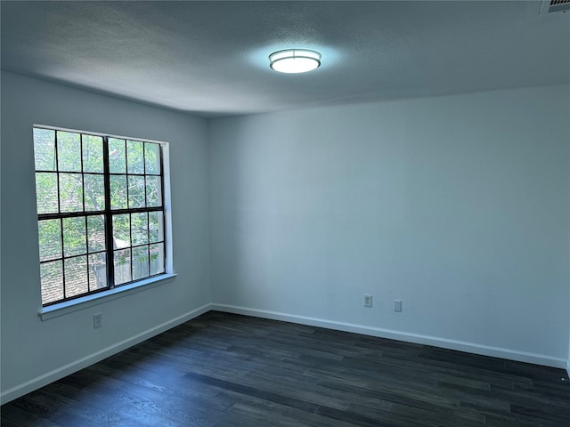 14800 Enterprise Dr Unit 17B, Farmers Branch, TX 75234 - empty room featuring dark wood-style floors, baseboards, and a textured ceiling