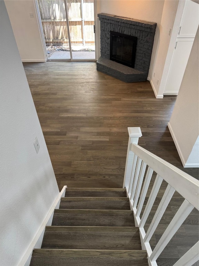 14800 Enterprise Dr Unit 17B, Farmers Branch, TX 75234 - stairs featuring wood finished floors, a fireplace, and baseboards