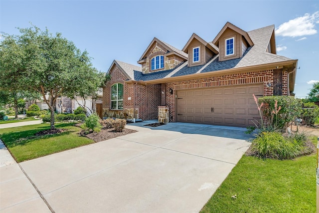 9728 Bitterroot Dr, Little Elm, TX 75068 - view of front of home featuring brick siding, a shingled roof, an attached garage, and concrete driveway