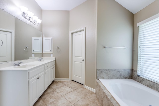 9728 Bitterroot Dr, Little Elm, TX 75068 - bathroom featuring double vanity, a garden tub, healthy amount of natural light, and tile patterned flooring