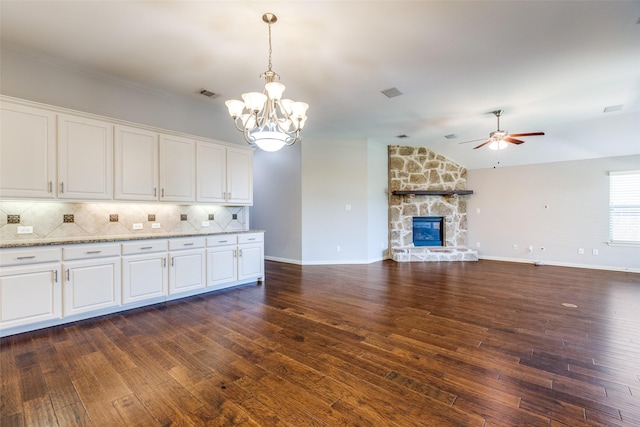 9728 Bitterroot Dr, Little Elm, TX 75068 - kitchen featuring a ceiling fan, a chandelier, white cabinets, vaulted ceiling, and backsplash