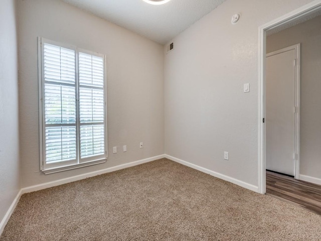 1603 Marsh Ln Unit 308, Carrollton, TX 75006 - unfurnished room featuring plenty of natural light, carpet floors, and baseboards