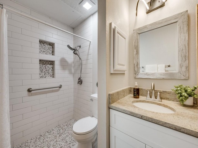 1603 Marsh Ln Unit 308, Carrollton, TX 75006 - bathroom with vanity, tiled shower, and toilet