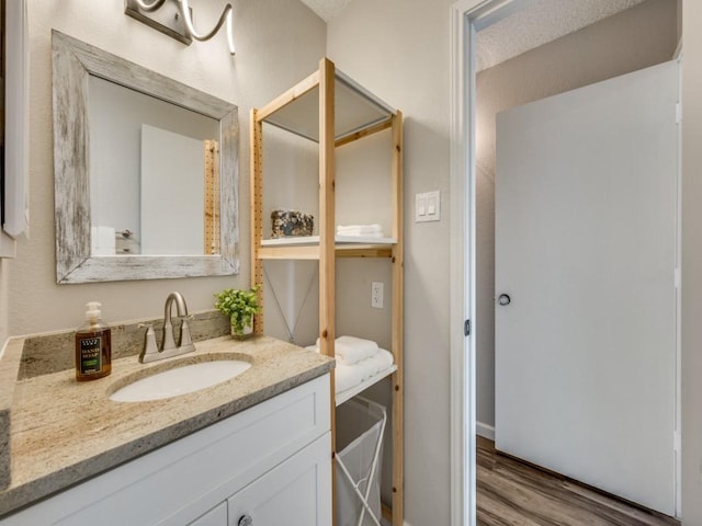 1603 Marsh Ln Unit 308, Carrollton, TX 75006 - bathroom with vanity and wood finished floors