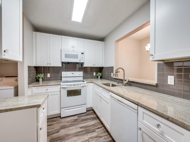 1603 Marsh Ln Unit 308, Carrollton, TX 75006 - kitchen featuring white appliances, a sink, white cabinetry, and backsplash