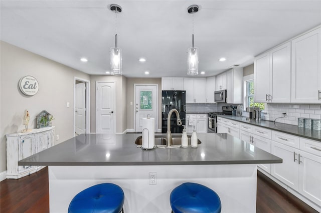 1105 Florence St, Mckinney, TX 75069 - kitchen featuring stainless steel appliances, dark countertops, backsplash, white cabinetry, and recessed lighting