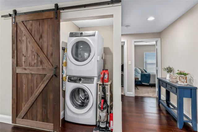 1105 Florence St, Mckinney, TX 75069 - laundry area featuring stacked washing machine and dryer, a barn door, wood finished floors, recessed lighting, and baseboards