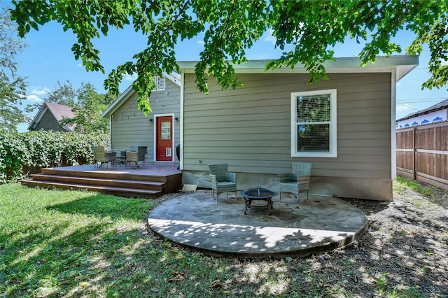 1105 Florence St, Mckinney, TX 75069 - back of property with a wooden deck, an outdoor fire pit, and a patio area
