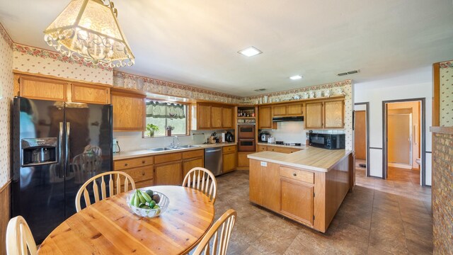 1133 Vz County Road 2205, Canton, TX 75103 - kitchen featuring black appliances, a sink, light countertops, under cabinet range hood, and wallpapered walls