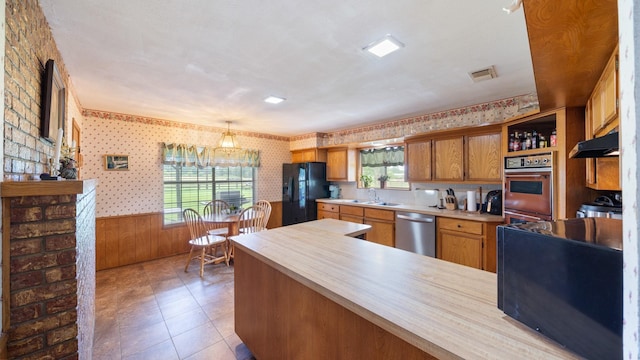 1133 Vz County Road 2205, Canton, TX 75103 - kitchen featuring stainless steel dishwasher, black fridge with ice dispenser, wallpapered walls, light countertops, and a sink