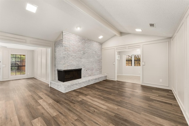 5008 Hatherly Dr, Plano, TX 75023 - unfurnished living room with a brick fireplace, a decorative wall, wood finished floors, and a textured ceiling