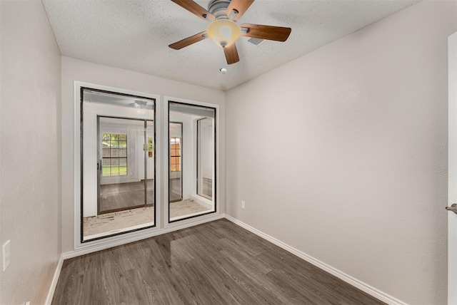 5008 Hatherly Dr, Plano, TX 75023 - unfurnished room featuring baseboards, dark wood finished floors, a ceiling fan, and a textured ceiling