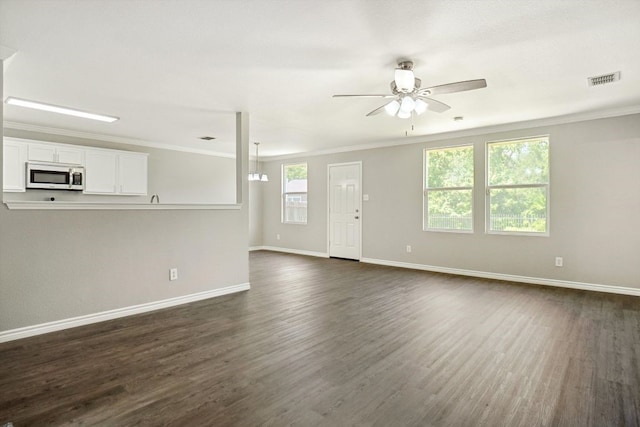 1713 Harvest Crossing Dr, Wylie, TX 75098 - unfurnished living room featuring ceiling fan, dark wood-style floors, baseboards, and crown molding
