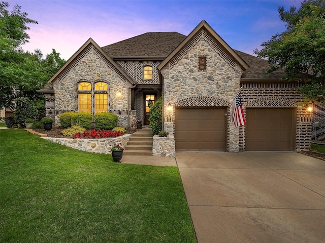 6420 Rosemary Ct, Mckinney, TX 75071 - french provincial home with stone siding, a garage, driveway, a lawn, and a shingled roof