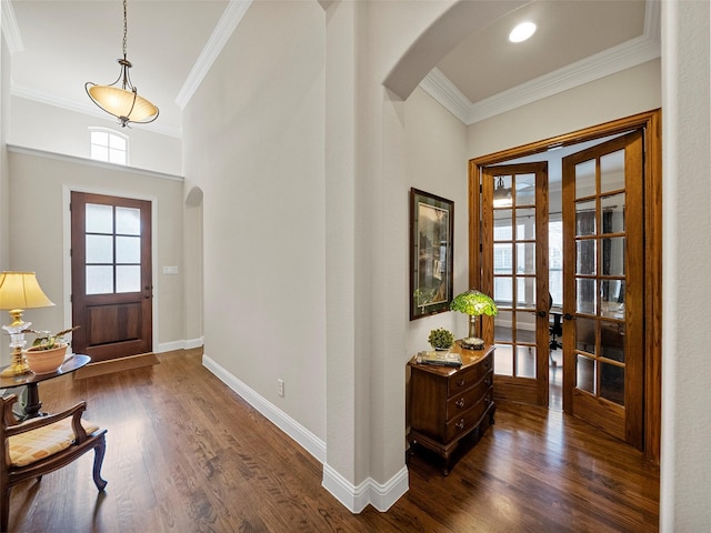 6420 Rosemary Ct, Mckinney, TX 75071 - foyer entrance featuring arched walkways, french doors, crown molding, dark wood-style floors, and baseboards