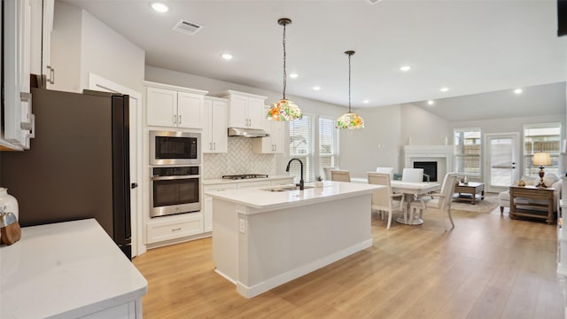 3201 Malcolm Rd, Melissa, TX 75454 - kitchen featuring stainless steel appliances, a sink, under cabinet range hood, open floor plan, and plenty of natural light