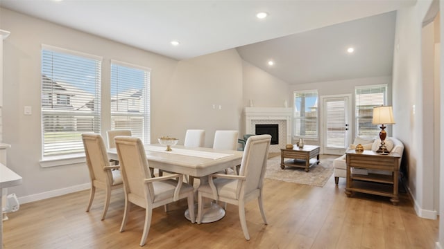 3201 Malcolm Rd, Melissa, TX 75454 - dining room featuring baseboards, light wood-style floors, a fireplace, recessed lighting, and vaulted ceiling