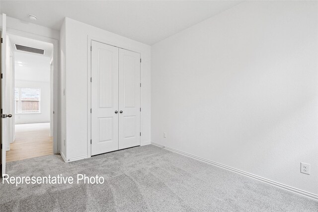2401 Ridgecrest Ln, Sherman, TX 75092 - unfurnished bedroom featuring carpet, a closet, and baseboards