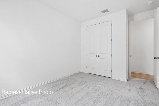 2401 Ridgecrest Ln, Sherman, TX 75092 - unfurnished bedroom featuring carpet floors, baseboards, and a closet