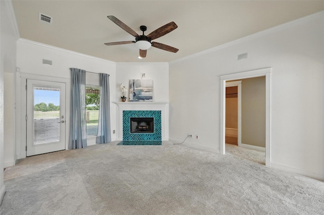 202 Centenial Ave, Ennis, TX 75119 - unfurnished living room featuring ornamental molding, a ceiling fan, carpet floors, a tile fireplace, and baseboards