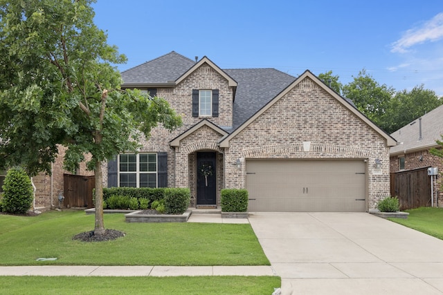 7717 Lake Worth Cv, Mckinney, TX 75071 - view of front of property with brick siding, a garage, a shingled roof, and concrete driveway