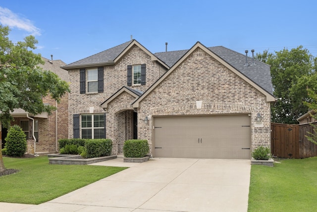7717 Lake Worth Cv, Mckinney, TX 75071 - traditional-style house with brick siding, concrete driveway, a garage, and a shingled roof