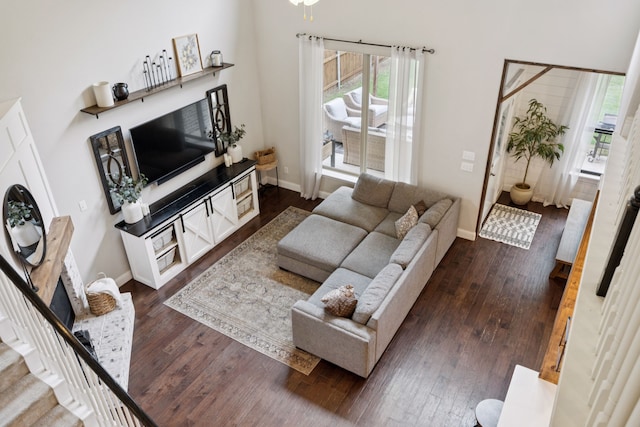 7717 Lake Worth Cv, Mckinney, TX 75071 - living area with dark wood finished floors, baseboards, and stairway