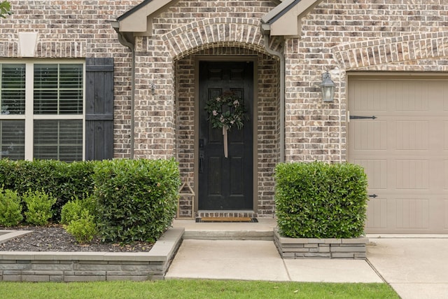 7717 Lake Worth Cv, Mckinney, TX 75071 - entrance to property featuring a garage, brick siding, and driveway