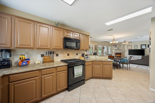 1230 Donegal Ln, Garland, TX 75044 - kitchen with black appliances, a chandelier, open floor plan, a peninsula, and light tile patterned flooring