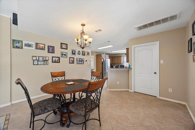 1230 Donegal Ln, Garland, TX 75044 - dining space featuring a chandelier, light tile patterned flooring, and baseboards