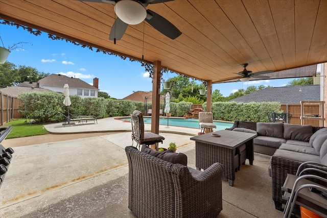 1230 Donegal Ln, Garland, TX 75044 - fenced backyard featuring a ceiling fan, an outdoor living space, and a patio area
