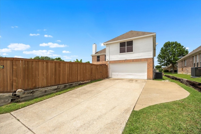 1230 Donegal Ln, Garland, TX 75044 - view of side of property with central AC, an attached garage, driveway, and a shingled roof