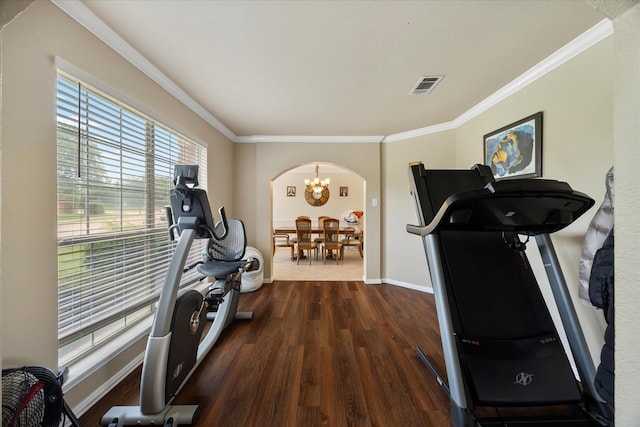 1230 Donegal Ln, Garland, TX 75044 - exercise room featuring dark wood-style floors, arched walkways, crown molding, baseboards, and a chandelier