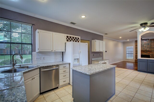 6613 Springmeadow Ln, Rowlett, TX 75089 - kitchen featuring stainless steel dishwasher, a sink, light tile patterned floors, a ceiling fan, and a center island