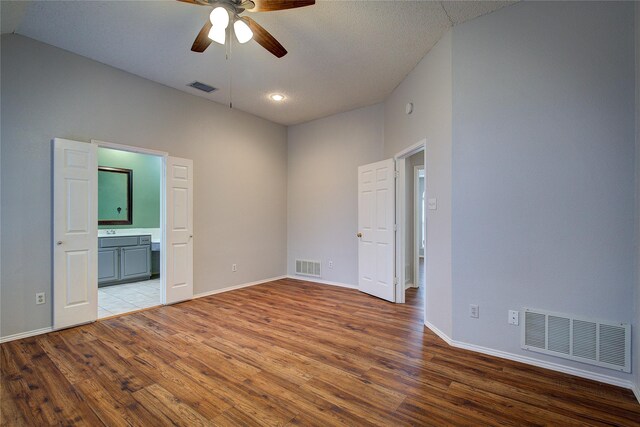 6613 Springmeadow Ln, Rowlett, TX 75089 - unfurnished bedroom with light wood-style floors, baseboards, connected bathroom, lofted ceiling, and a ceiling fan