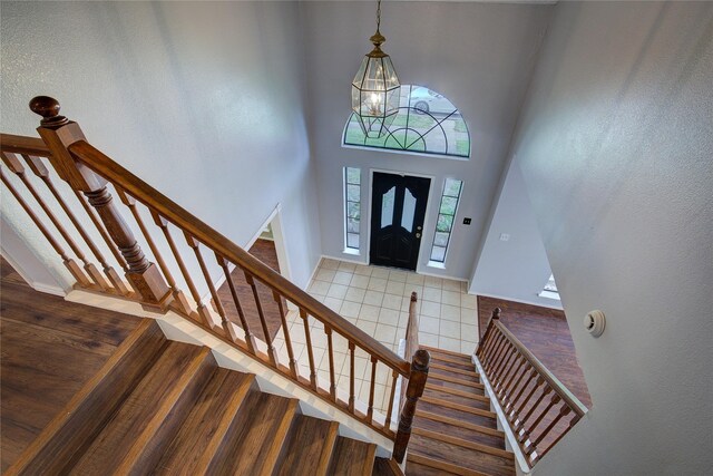 6613 Springmeadow Ln, Rowlett, TX 75089 - foyer entrance featuring stairway, tile patterned floors, a chandelier, and a high ceiling