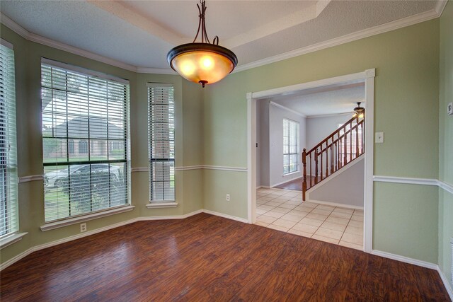 6613 Springmeadow Ln, Rowlett, TX 75089 - unfurnished room featuring wood finished floors, ornamental molding, baseboards, stairway, and a textured ceiling