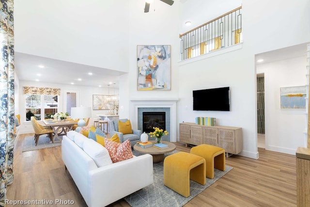 1624 Palo Duro Way, Celina, TX 75009 - living room with wood finished floors, a fireplace, ceiling fan, a high ceiling, and baseboards