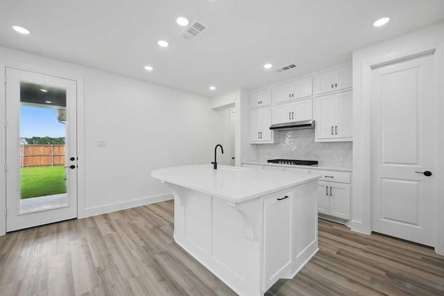 1624 Palo Duro Way, Celina, TX 75009 - kitchen featuring light countertops, a sink, a center island with sink, white cabinetry, and black stovetop