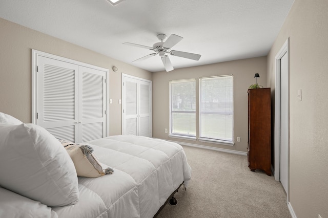 7213 Maranatha Ct, Colleyville, TX 76034 - bedroom featuring multiple closets, light carpet, a ceiling fan, and baseboards