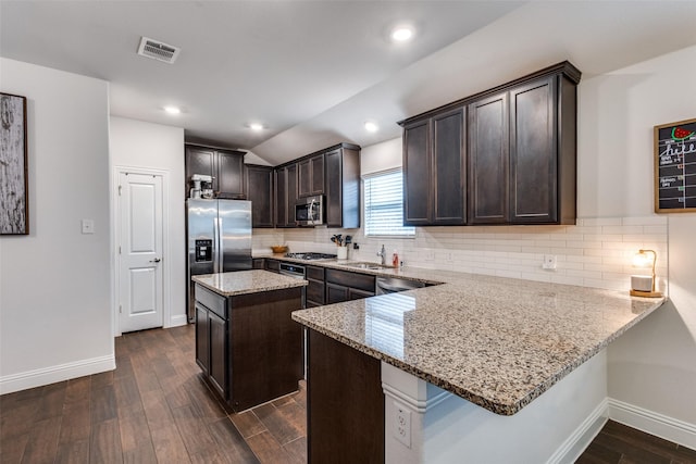 3822 Brazos St, Melissa, TX 75454 - kitchen with appliances with stainless steel finishes, dark brown cabinetry, baseboards, light stone countertops, and dark wood-style floors