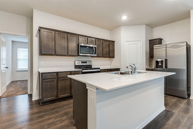 1937 Duskwood Dr, Lancaster, TX 75146 - kitchen featuring appliances with stainless steel finishes, dark brown cabinetry, dark wood finished floors, a kitchen island with sink, and recessed lighting