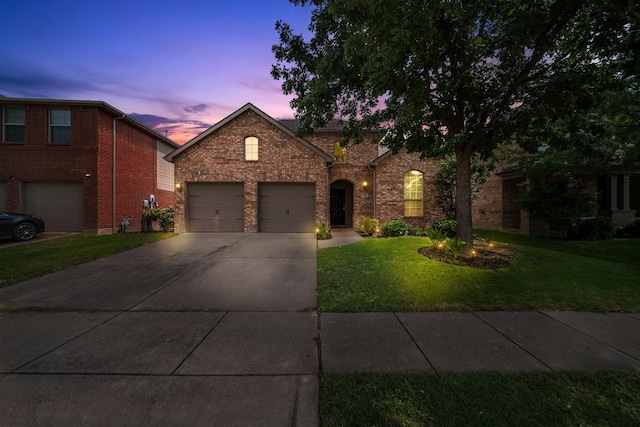 334 Hawthorn Dr, Fate, TX 75087 - traditional-style home with driveway, a lawn, brick siding, and a garage