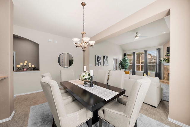 334 Hawthorn Dr, Fate, TX 75087 - carpeted dining space with a chandelier, baseboards, a ceiling fan, a fireplace, and lofted ceiling