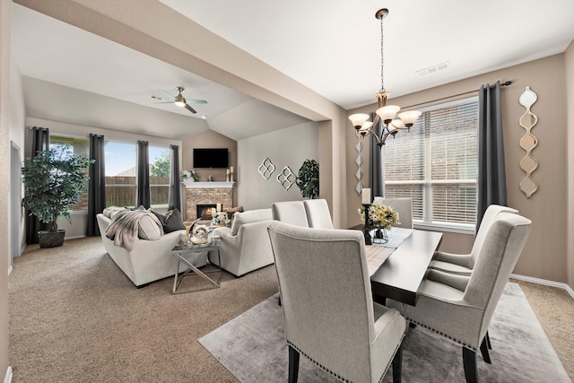 334 Hawthorn Dr, Fate, TX 75087 - dining room with light carpet, a chandelier, ceiling fan, a warm lit fireplace, and lofted ceiling