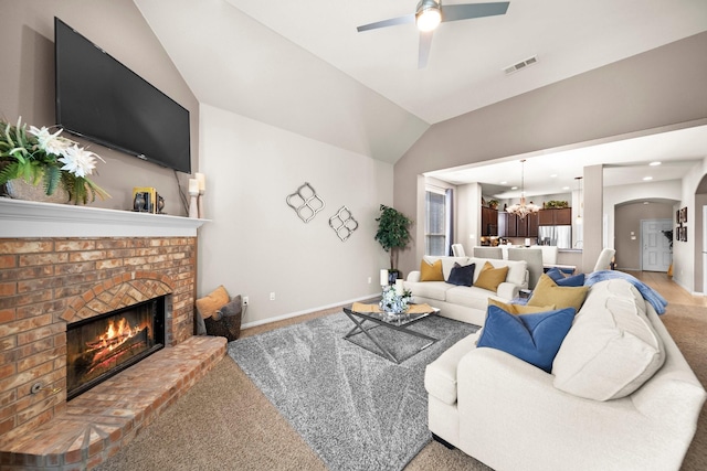 334 Hawthorn Dr, Fate, TX 75087 - living room with a ceiling fan, a fireplace, lofted ceiling, light colored carpet, and a chandelier