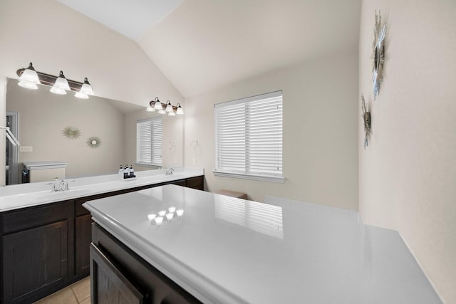 334 Hawthorn Dr, Fate, TX 75087 - bathroom featuring vaulted ceiling, double vanity, and tile patterned floors