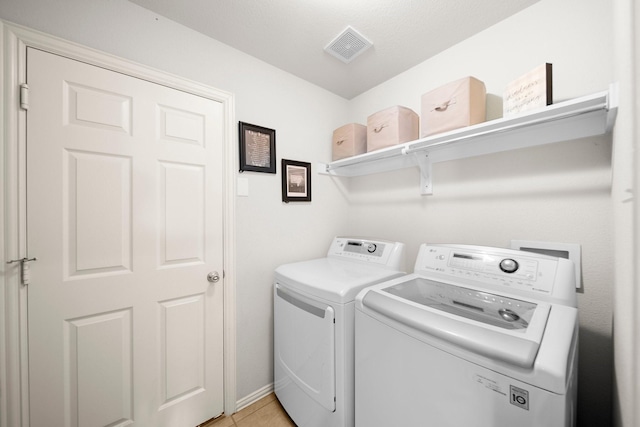 334 Hawthorn Dr, Fate, TX 75087 - laundry area featuring washing machine and dryer and light tile patterned flooring